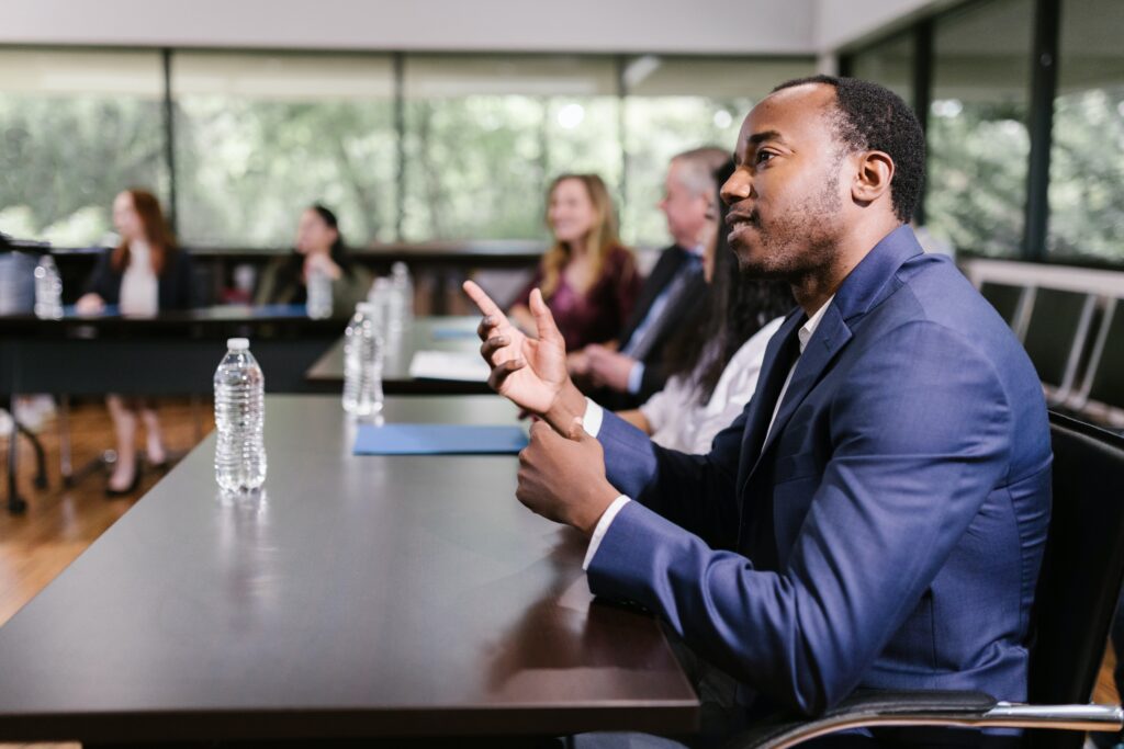 An attendee asks the presenter a question during a work conference.