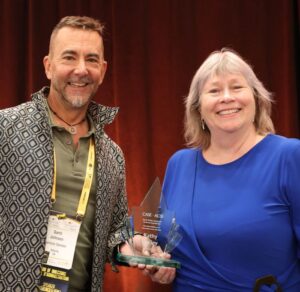 Garth Johnson and Kathy Malley holding the award.