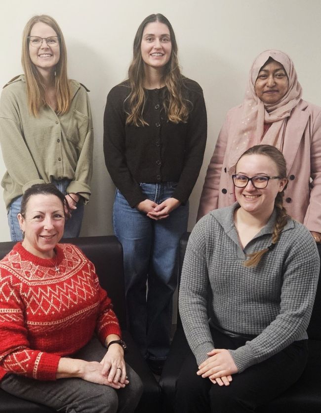 The ARC team: 5 people standing or sitting.