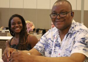 Two conference attendees smile.