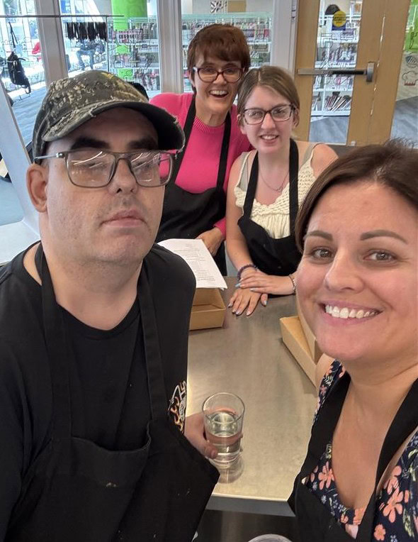 Two people in front and 2 people in the back, all smiling.