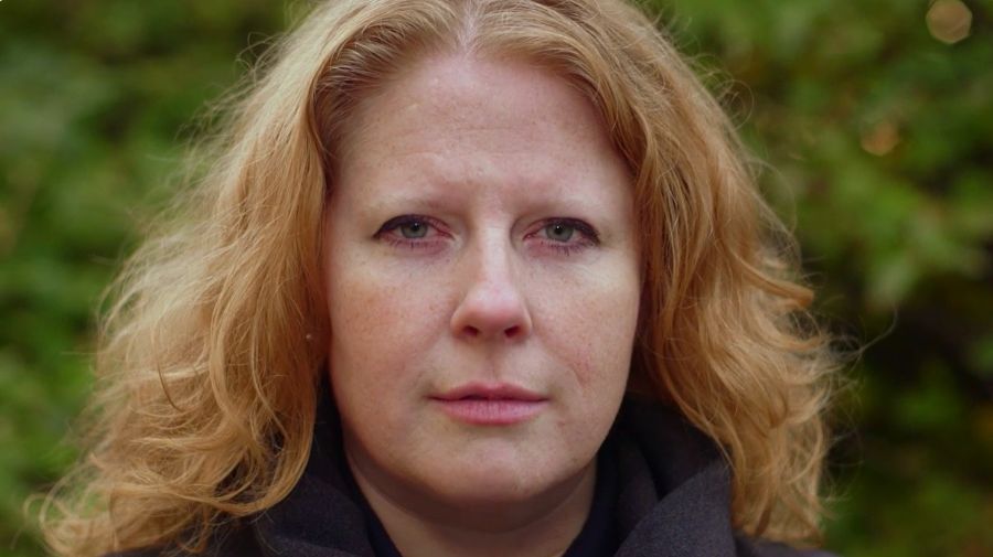 A woman looks at the camera
