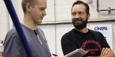 Two people talking while working