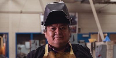 Indigenous welder in a shop